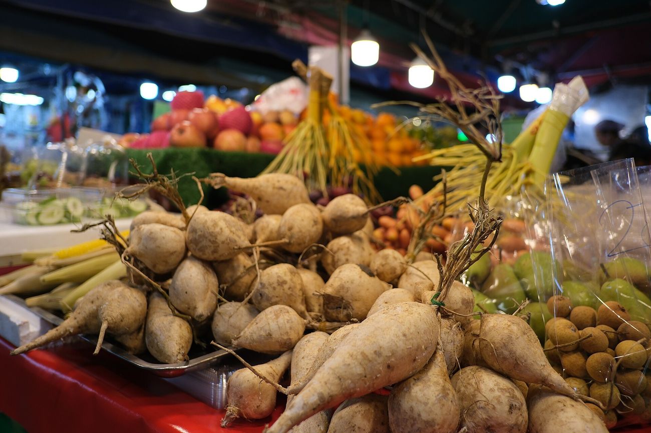Produce piled high at a bustling market stall